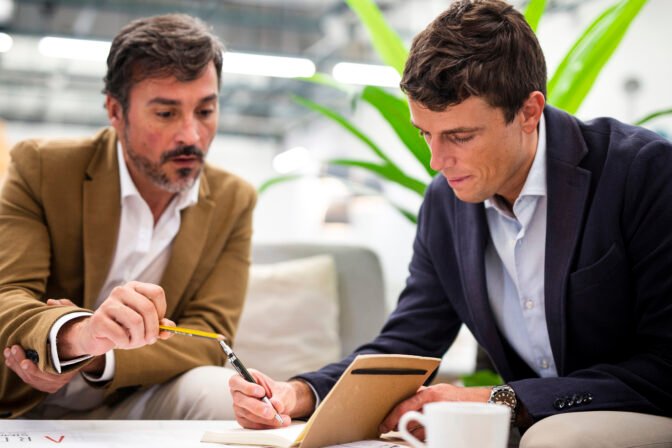 low-angle-male-coworkers-meeting-office